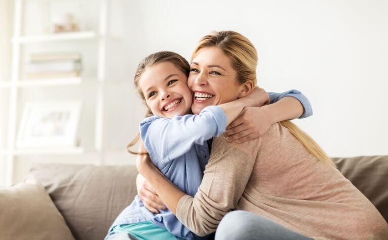 Mother and daugher smiling